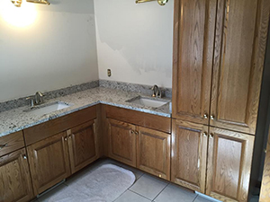 Old vanity and wooden cupboards before remodel